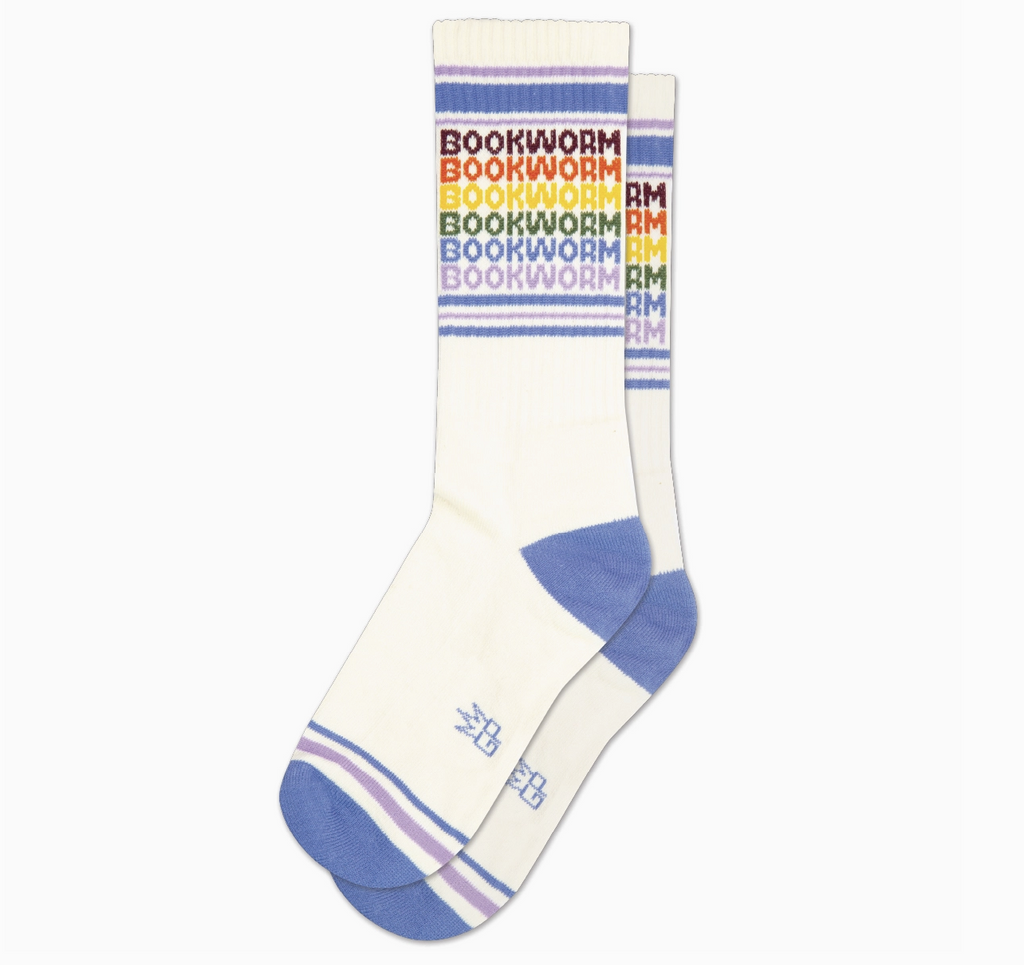 White tube socks with light blue and purple stripes with "Bookworm" repeated in rainbow colors. 