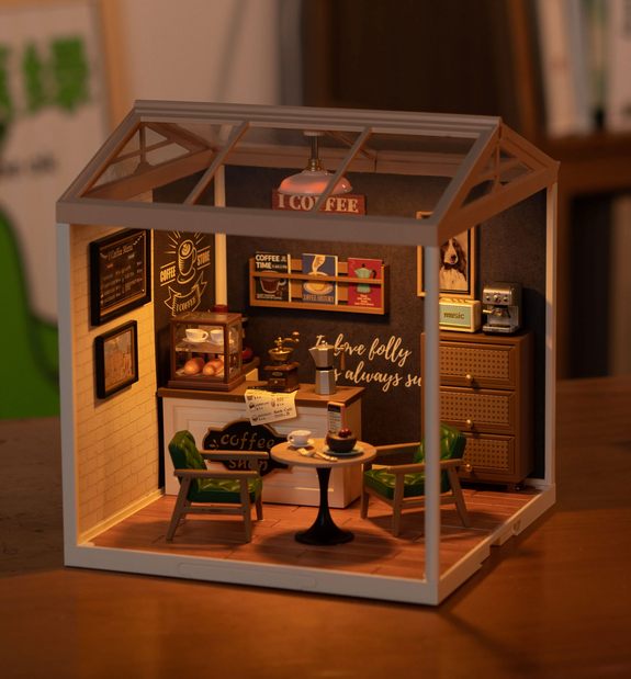The Breezy Time Cafe Miniature House Kit with the lights illuminated and the separately availbale roof and walls attached. 