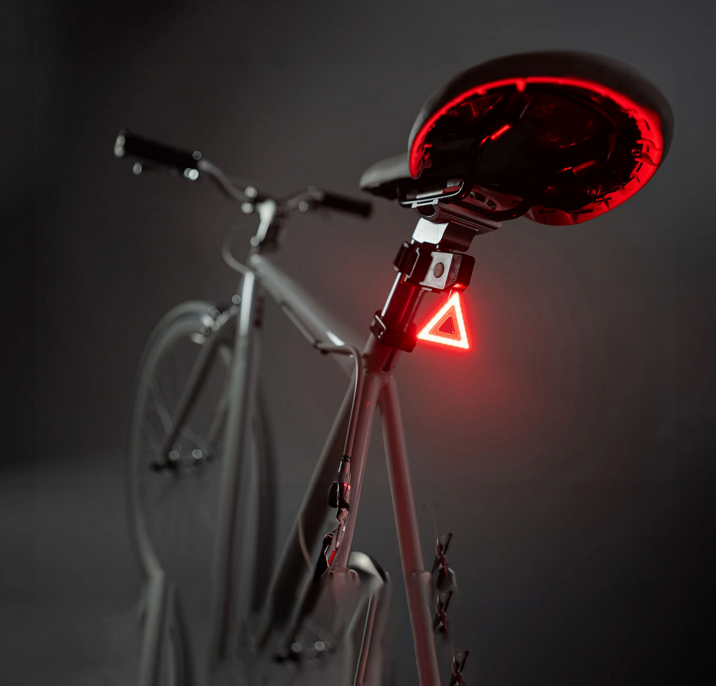 A bicycle with the Brightz Triangle Taillight illuminated on the back underneath the seat. 
