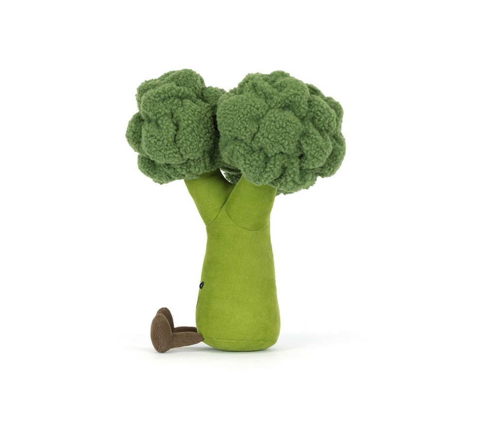 Side view of a plush green broccoli on a white background.
