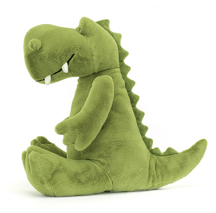 Side view of Bryno Dino with his apple-green fur and bobbly brow, knobbled nostrils, suedette tusks and huge squashy feet, as well as a wedge tail embroidered with spines.