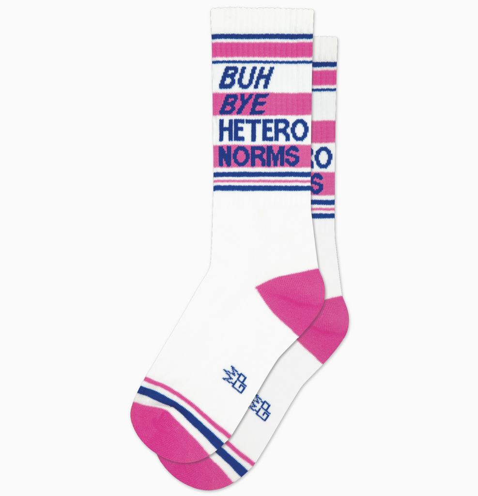 White tube socks with hot pink and blue stripes that read " Buh Bye Hetero Norms" in blue letters. 