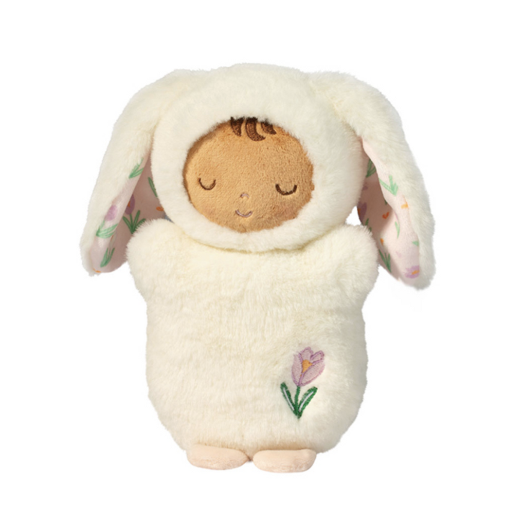 Adorable plush baby doll in a soft white bunny costume that has a hood with long bunny ears and a sweet floral pattern on the inside. 