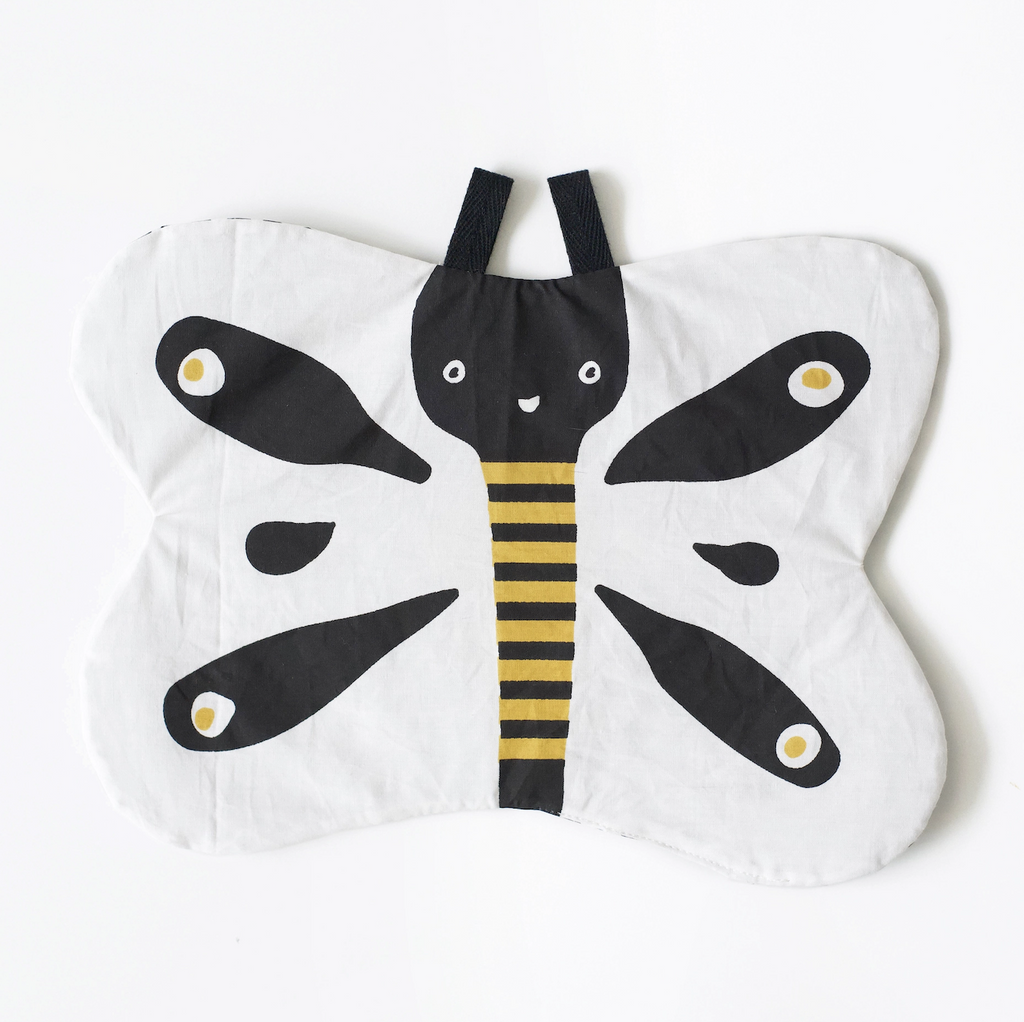 Flat baby crinkle toy, shaped like a butterfly with white, black and yellow contrasting colors. 