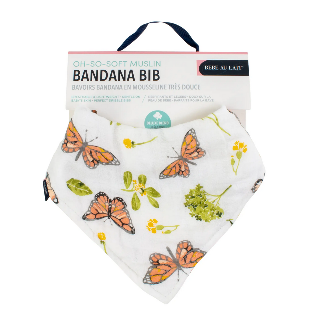 Muslin bib with butterfly and flowers printed on a white background. 