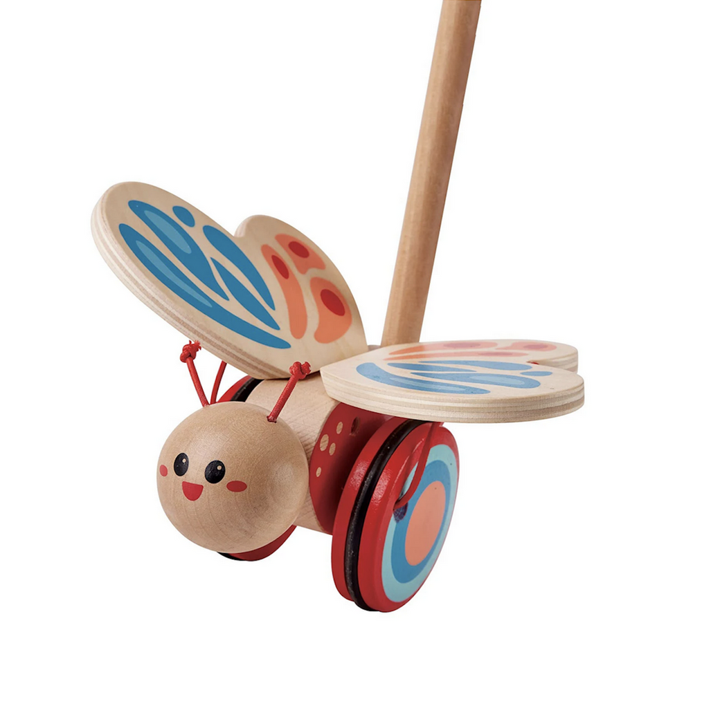 The wooden butterfly with red and blue  painted wings and cheerful, happy face. 