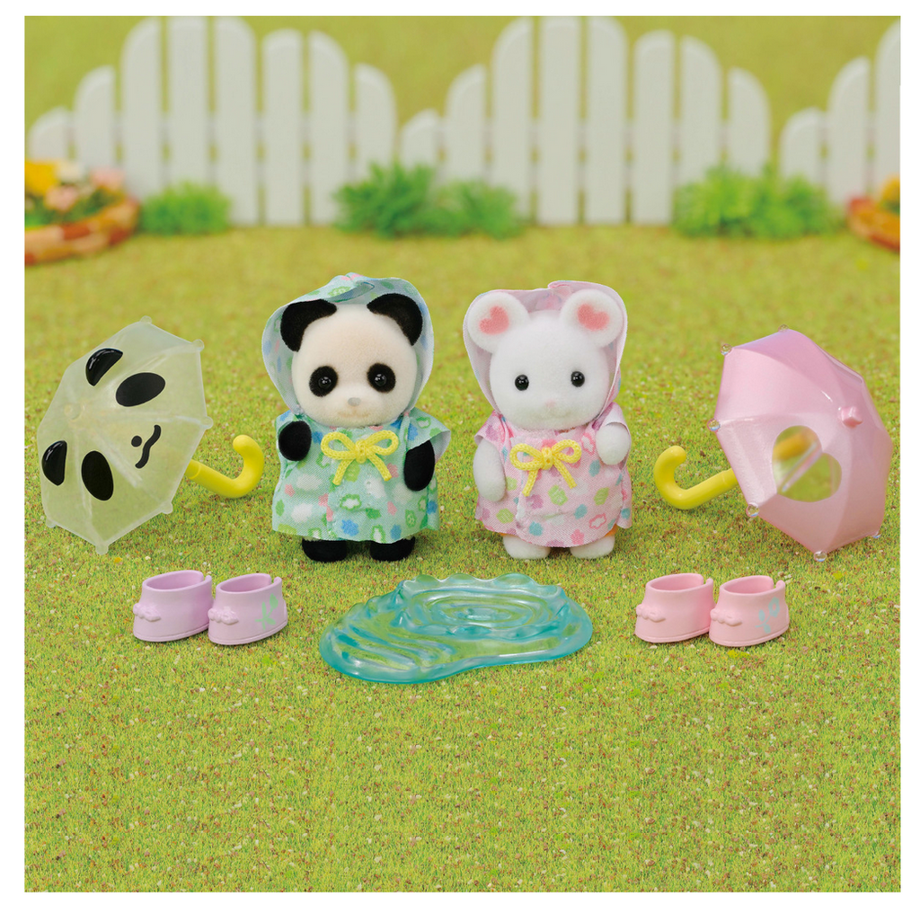 Calico Critters Rainy Day Duo figures and accessories on a green grass background.