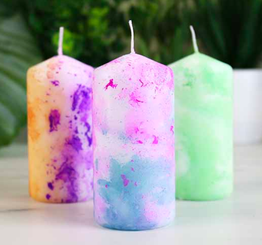 Three marbled candles made using the kit. 