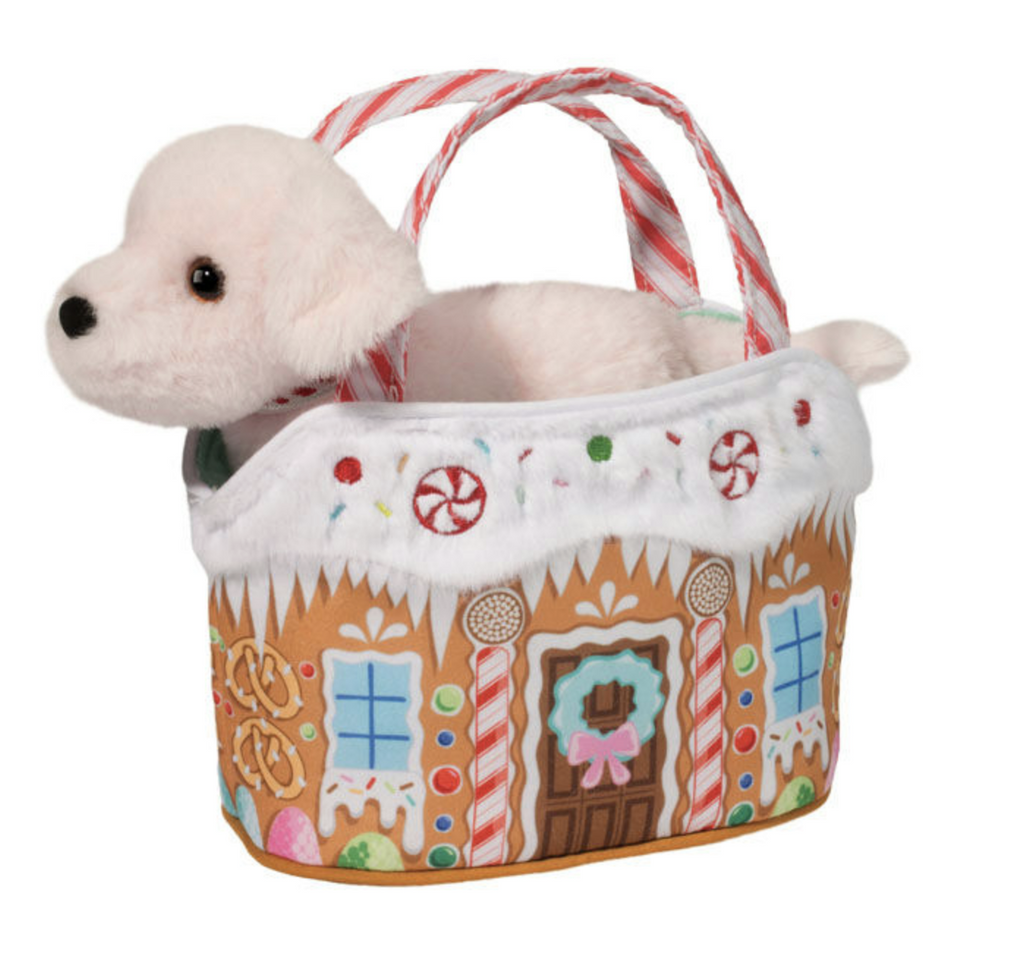 The cutest little pink puppy inside a plush purse that looks like a festively decorated gingerbread house. 