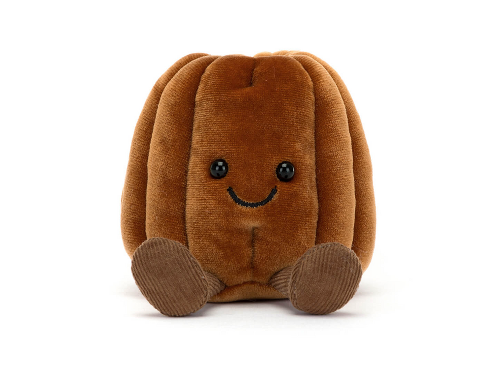 A brown plush toy shaped like a pumpkin or acorn with a smiling embroidered face and small corduroy feet, photographed on a clean white background.