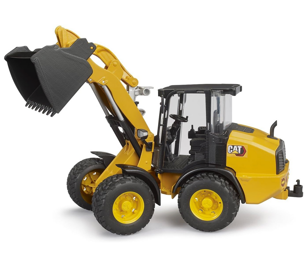 The Cat Wheel Loader toy with the loader raised in the air as if it just dumped a load on the job site. 