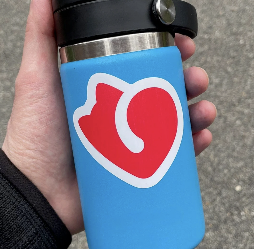 Cat rescue sticker of a red cat shaped heart with white outline on a blue water bottle. 