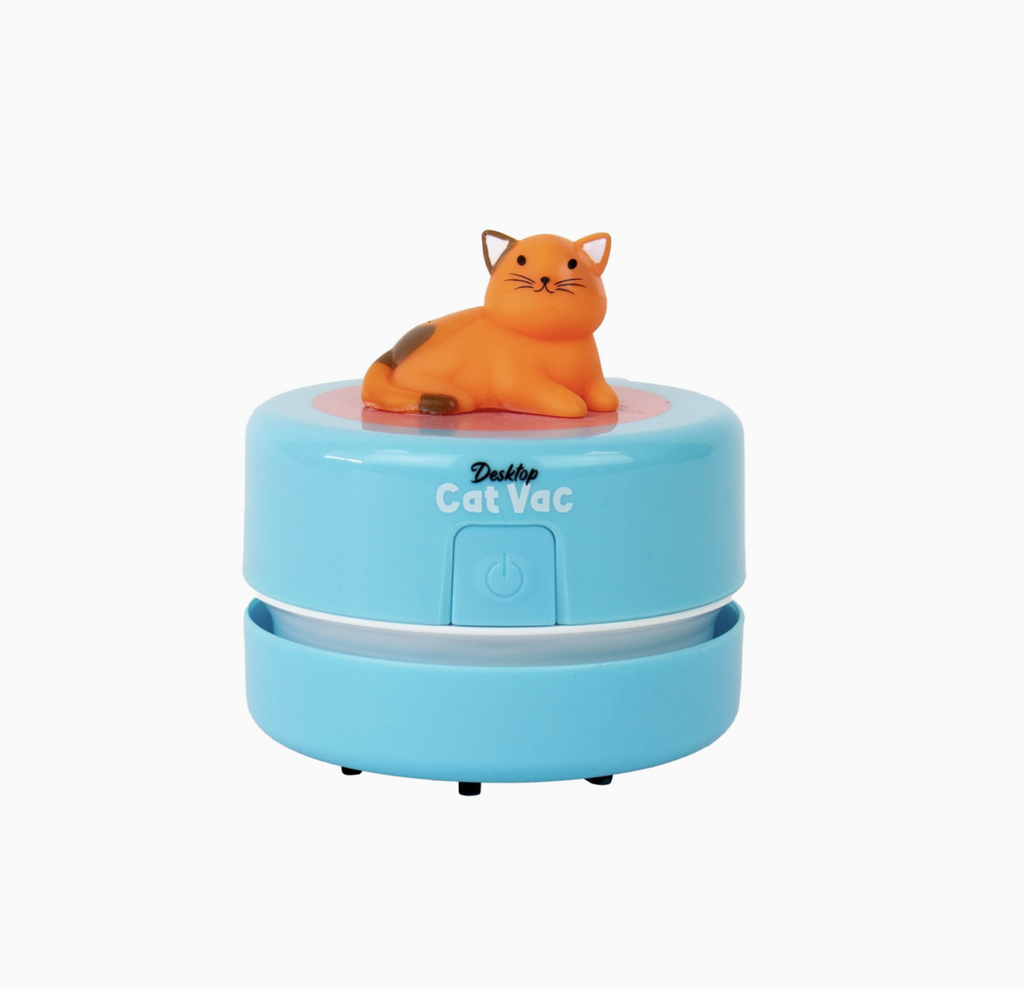 Small desktop vacuum with a orange plastic cat on top on a white background