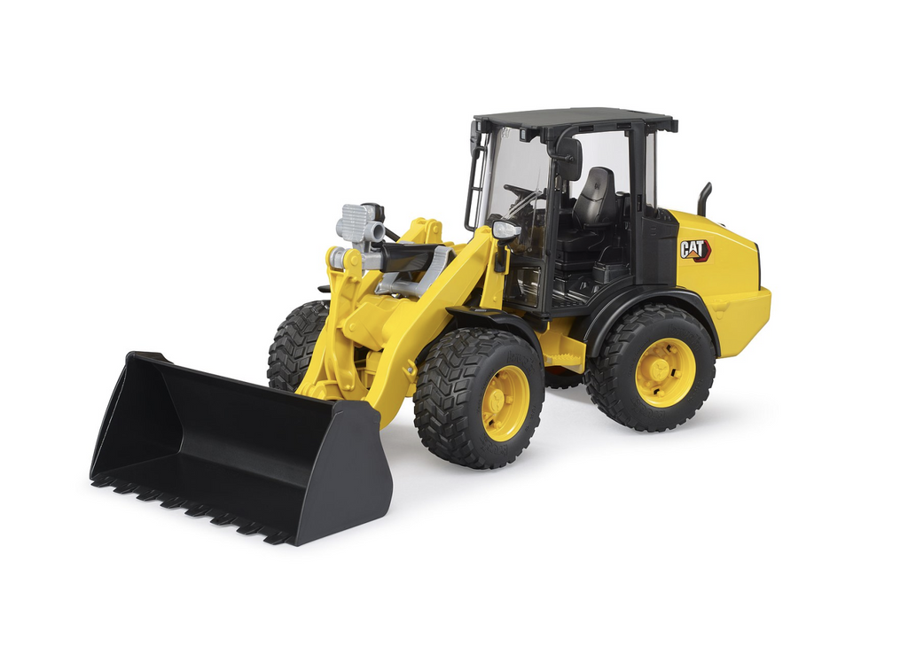 A big yellow Cat Wheel Loader with the loader bucket ready for a job on the job site. 