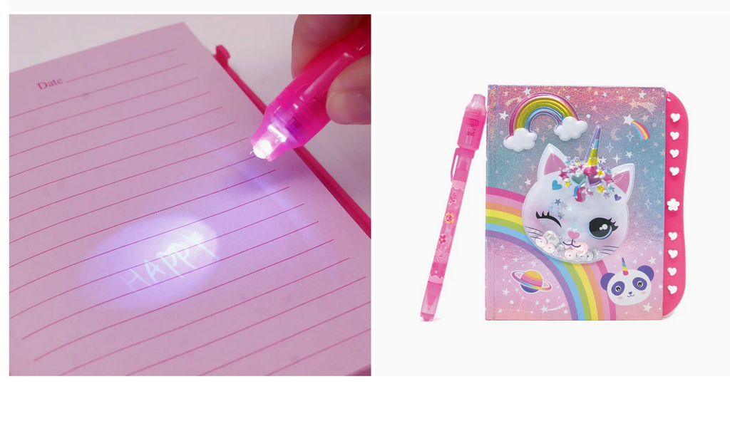 Image of secret message on lined paper being revealed with the included light on the pen and the pen next to the caticorn journal.
