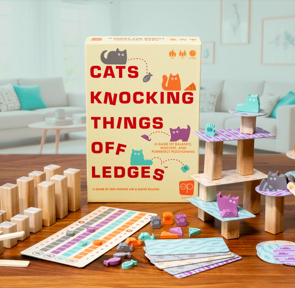 Cat Knocking Things Off Ledges game in the middle of a game with towers built and cat game pieces lounging all around. 
