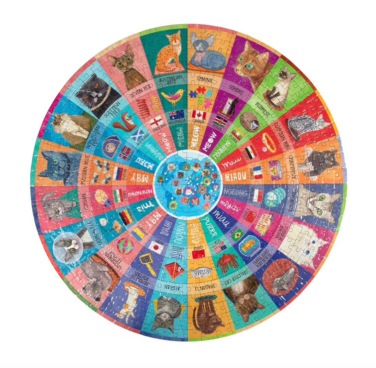 Round 500 piece puzzle. Each breed has its own color sliver that provides the name of the breed, the flag of its native country, how you say “woof” or “ guau” in that country’s language. 