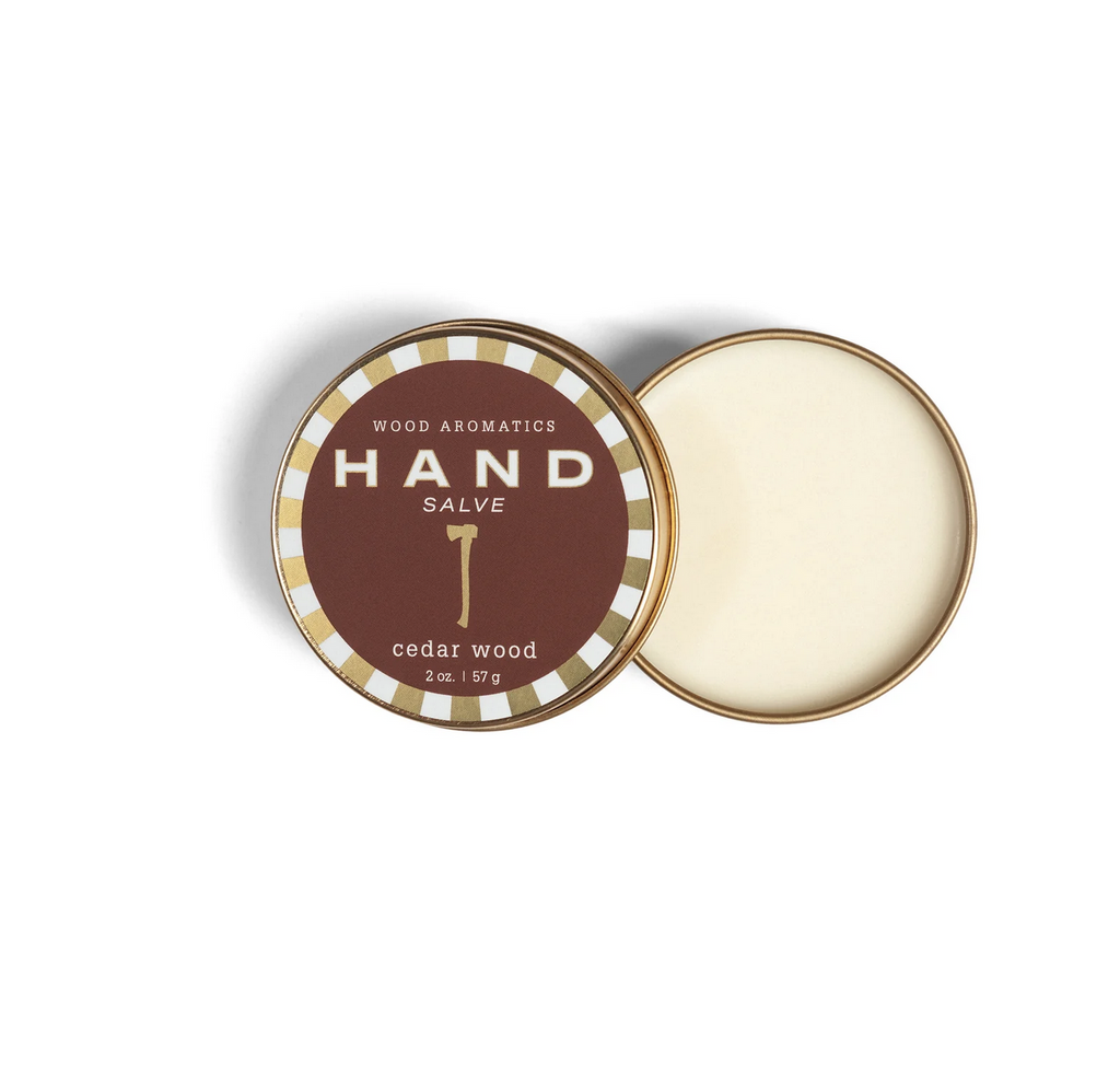 Hand salve tin with an illustrated axe with text that reads: " Wood Aromatics Hand Salve Cedar Wood, 2 oz."