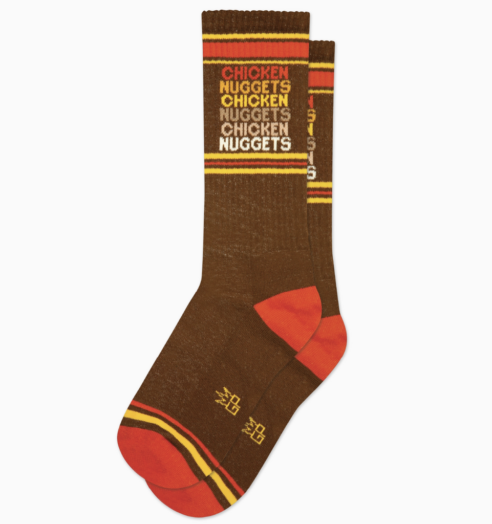 Dark brown tube socks with yellow and orange stripes that read "Chicken Nuggets" in a repeating pattern. 