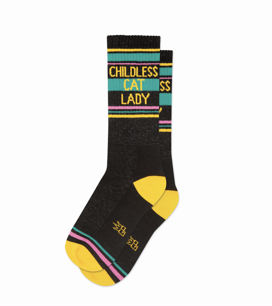 Black crew sock with yellow, teal, and hot pink bands. Yellow text reads Childless Cat lady.