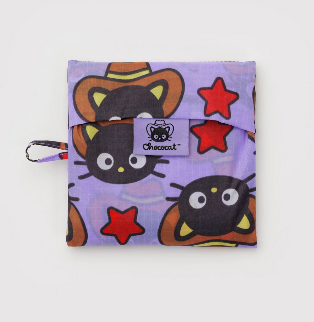 Purple reusable Baggu bag folded into it's flat pouch with Chococat  western pattern. 
