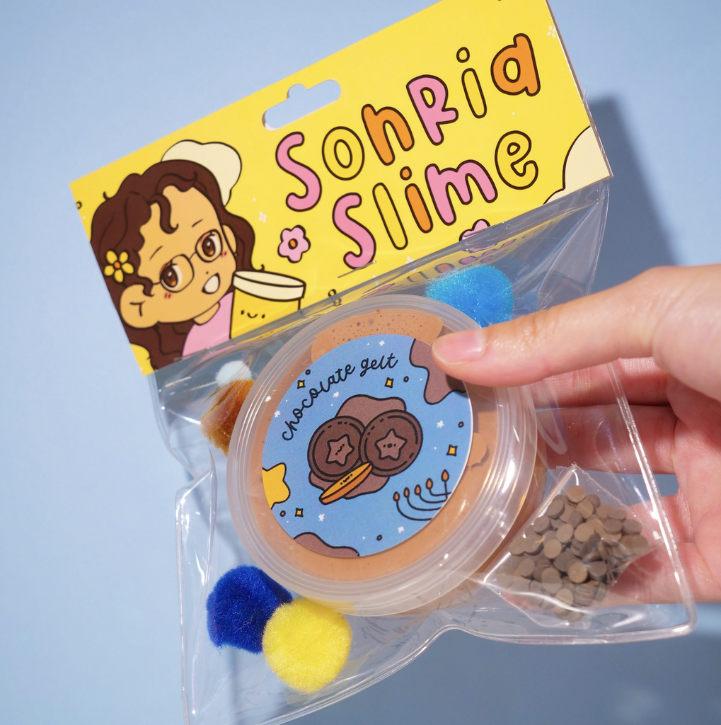 Chocolate Gelt Slime from Sonria Slime packaged in a clear bag with a 4oz slime and chocolate gelt add ins. (Not food)