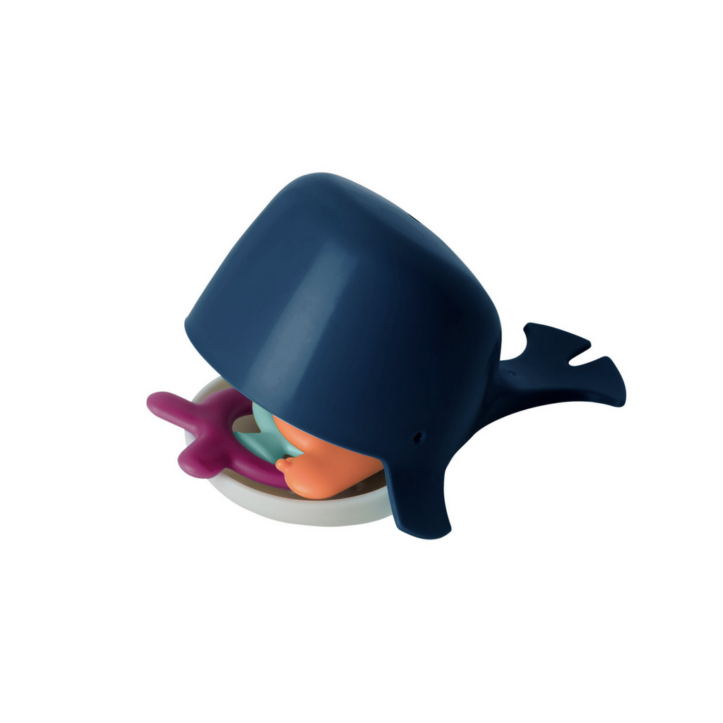 Dark blue whale silicone bath toy with smaller toys in mouth on white background.