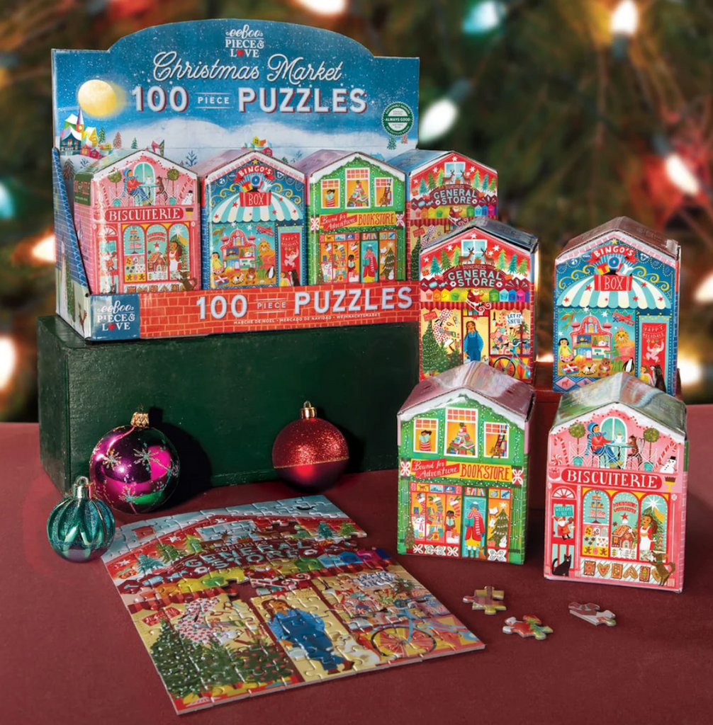 Christmas market-themed puzzle assortment with four styles and puzzle pieces on a table.
