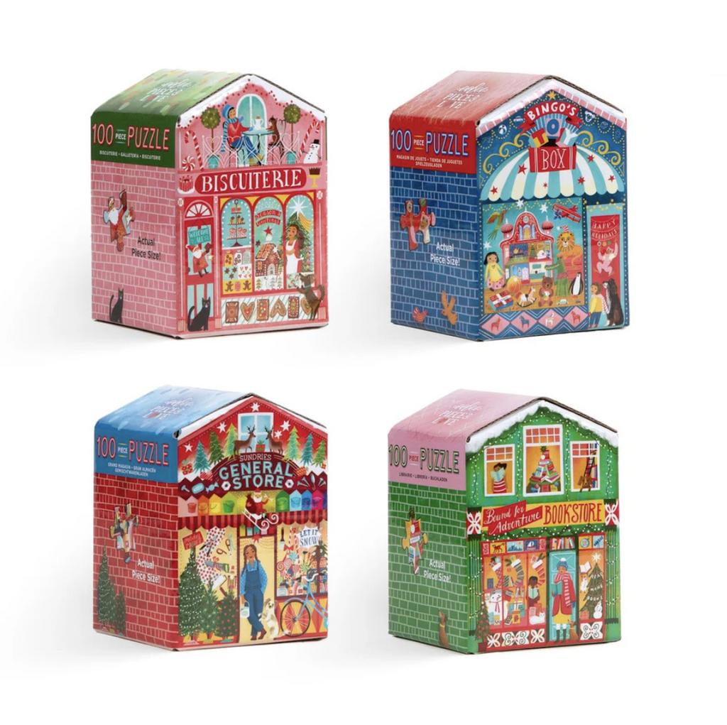 Four puzzle boxes shaped like stores during the holiday season with themes such as a bookstore, general store, toy store and bakery.