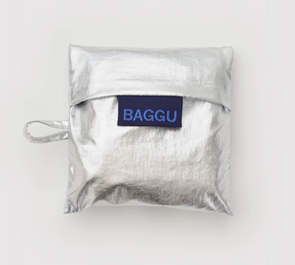 Metallic Silver Baby Baggu folded into it's flat storage pouch. 