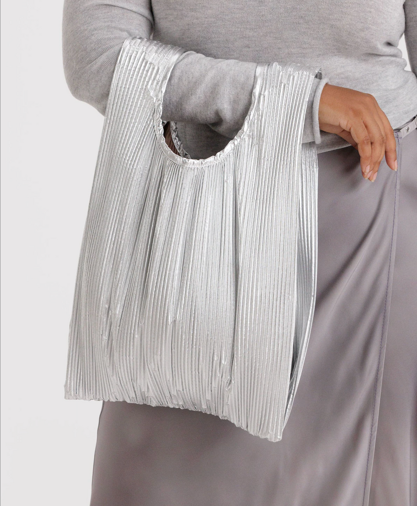 Person holding the Pleated Metallic Chrome Baggu reusable bag. 