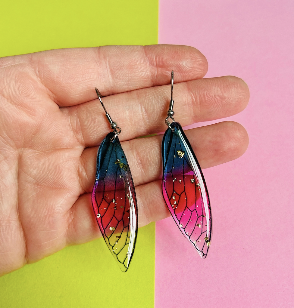 Blue and pink cicada earrings with gold flecks. 