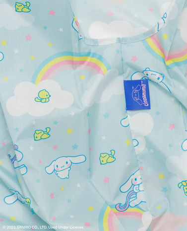 Close up view of the Cinnamoroll baggu pattern with a light blue background and Cinnamoroll, rainbows, a little yellow friend and pink, blue and yellow stars. 