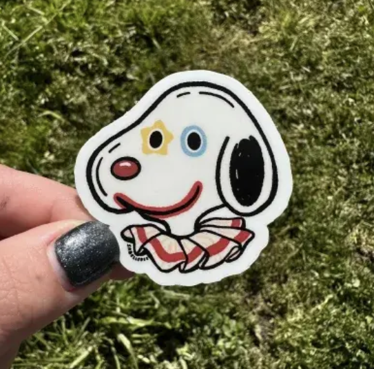 Vinyl sticker of Snoopy with clown makeup and collar.