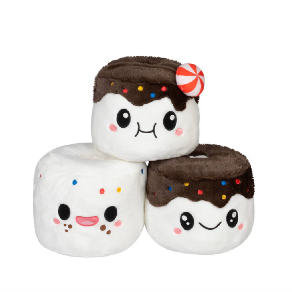 Stack of plush marshmallow toys with chocolate hats and colorful sprinkles. 