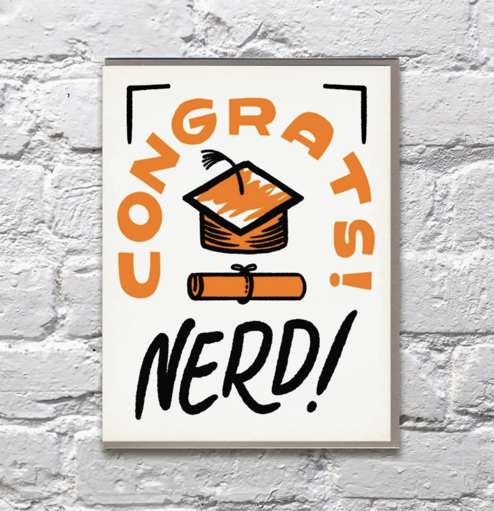 Gradation greeting card with an illustrated cap and diploma that reads "Congrats Nerd!" 