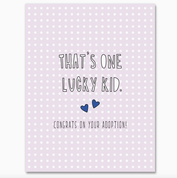 Light purple background with white polka dots greeting card that reads "That's One Lucky Kid. Congrats on Your Adoption!"