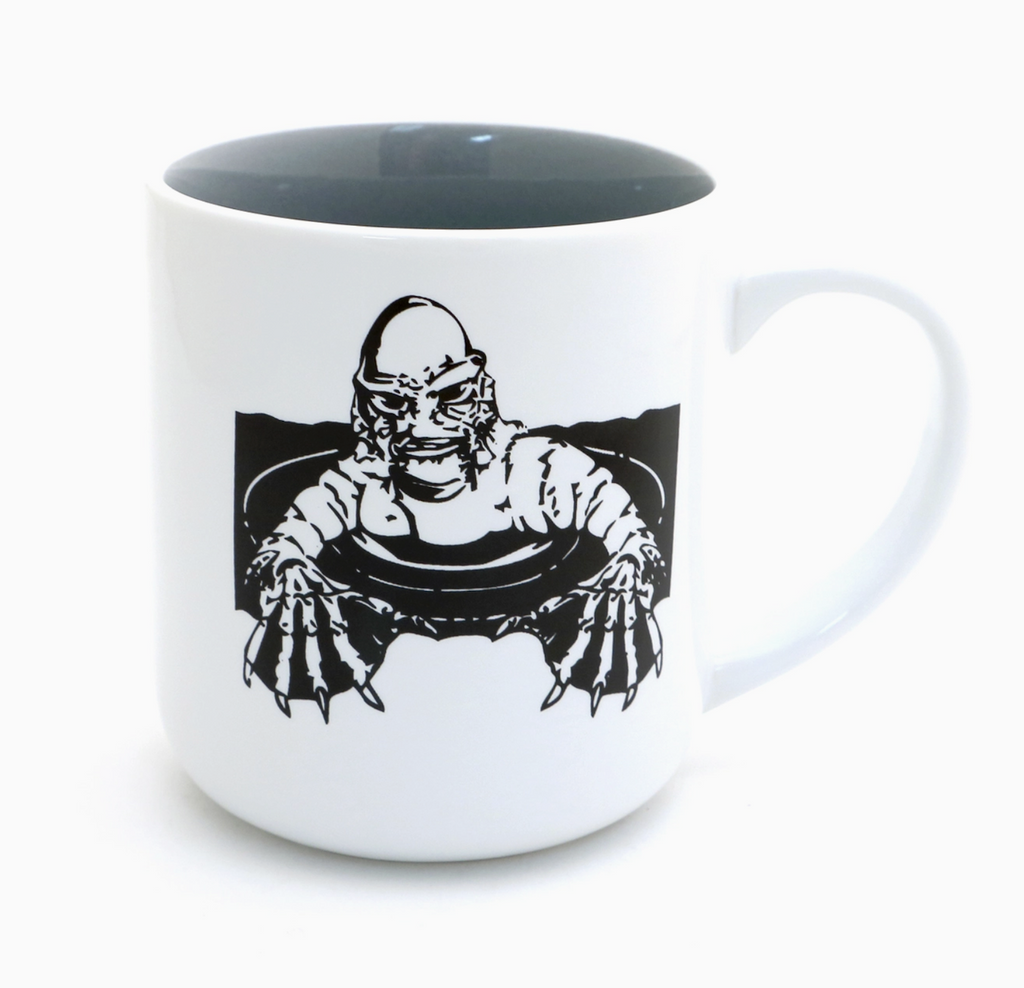 White stoneware mug with black graphic of The Creature from the Black Lagoon printed on the front. 