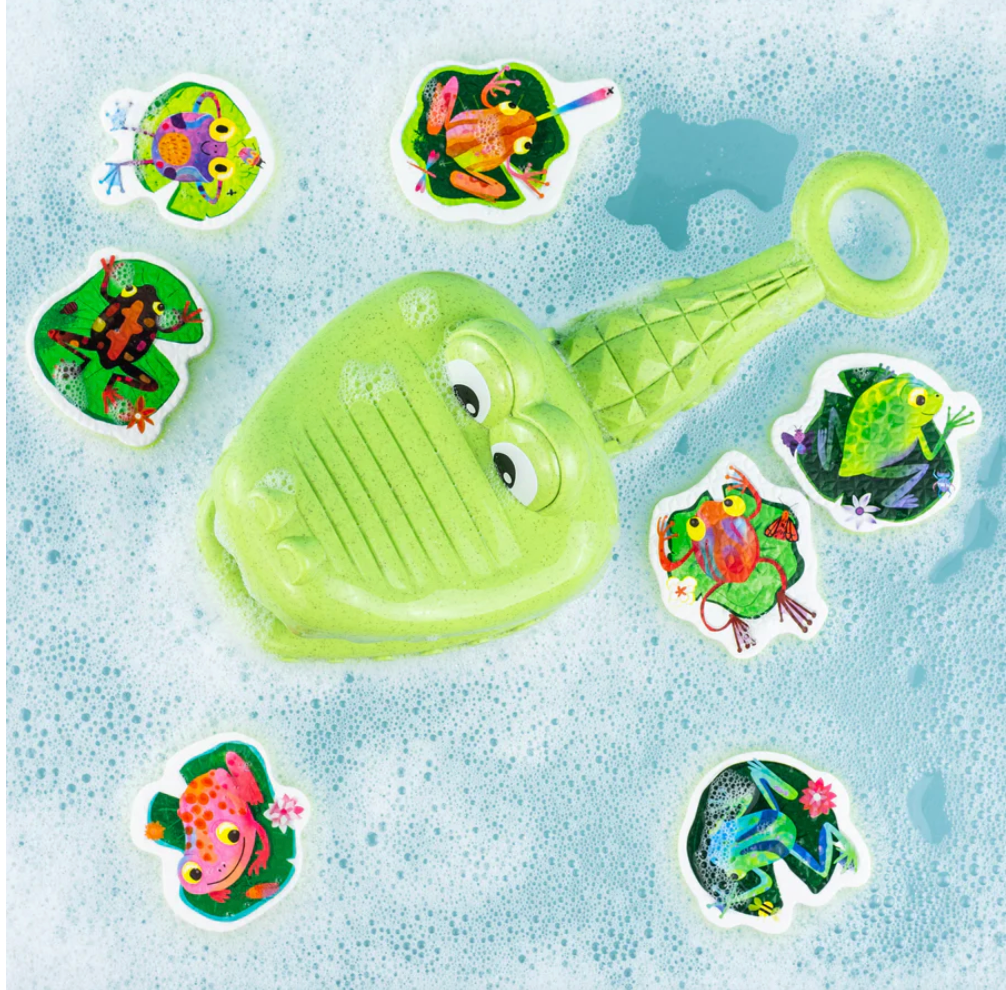 Green bath toy with floating foam frogs  on a blue, bubbly background