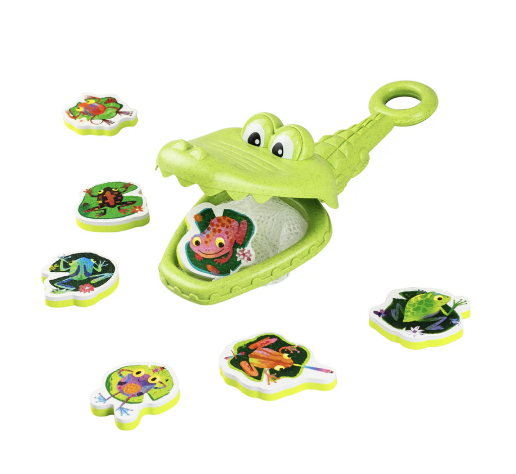 Green Crocodile bath toy surrounded by foam frogs on a white background.