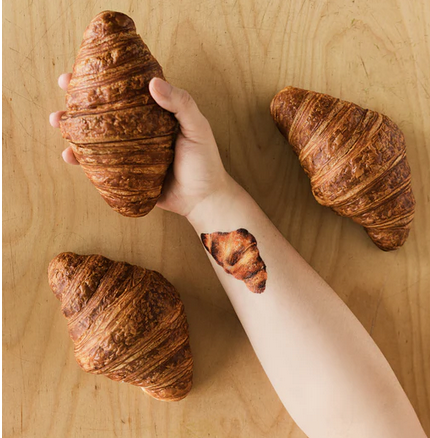 Croissant tattoo applied on an arm.