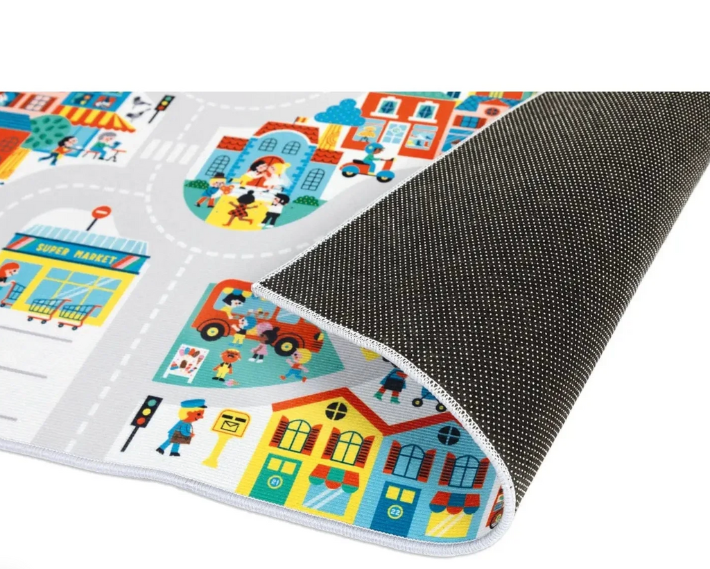 The Cross Roads City Playmat with the edge pulled up to show the non slip underside. 