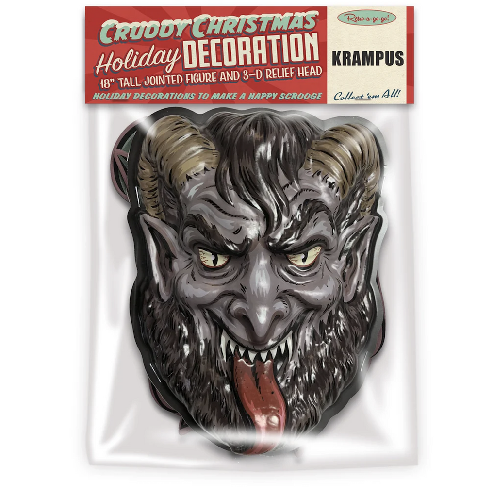 3D Krampus head bearing it's teeth and sticking out it's tongue packaged in a clear bag. With an illustrated red header card that reads Cruddy Christmas Holiday Decoration.