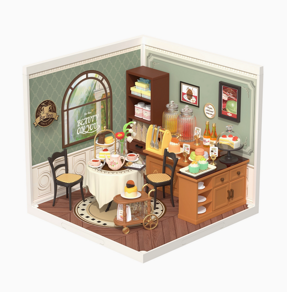 Close up picture of the Sweet Sips Tea room with a miniature table set with a teapot and treats. 