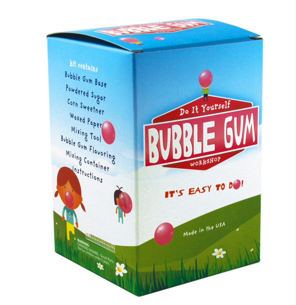 DIY Bubble Gum Kit packaged in a box with illustration of a green meadow and blue sky and lots of kids blowing big bubbles with the bubble gum they made using the kit. 