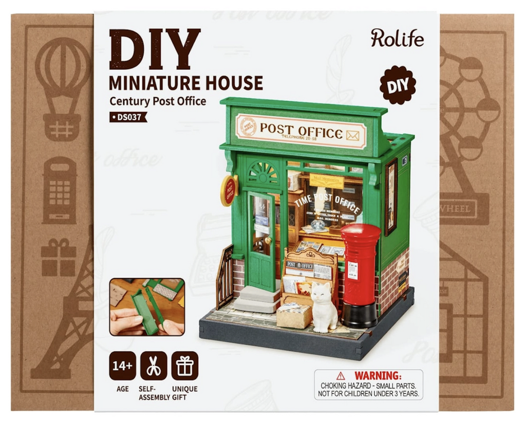 Century Post Office DIY Miniature House Kit packaged in a brown box with a color picture of the Century Post Office assembled with all of the miniature accessories. 