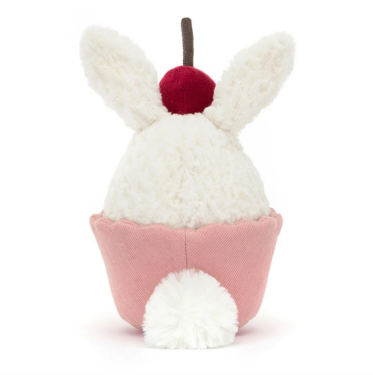 The Dainty Dessert Bunny Cupcake from the back, it's white tail is peeking out from the cupcake. 