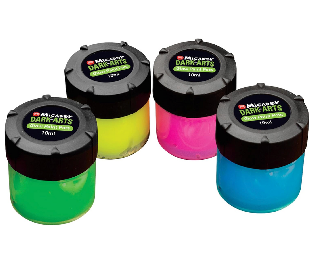 Set of four paint pots in green, yellow, pink and blue from the Dark Arts Glow Paint Pots. 