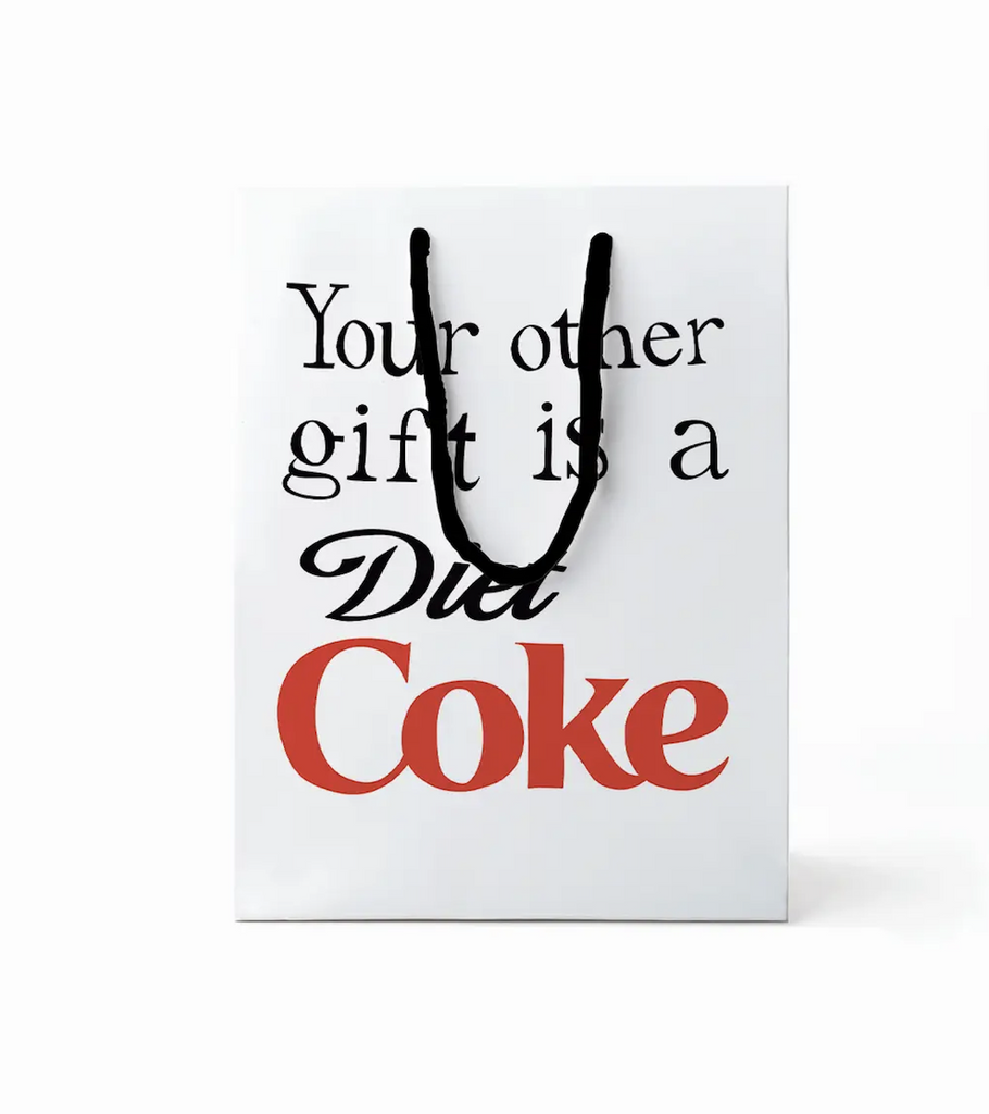 Large gift bag with handles that read "Your other gift is a Dire Coke' with the familiar font and colors of the classic label. 