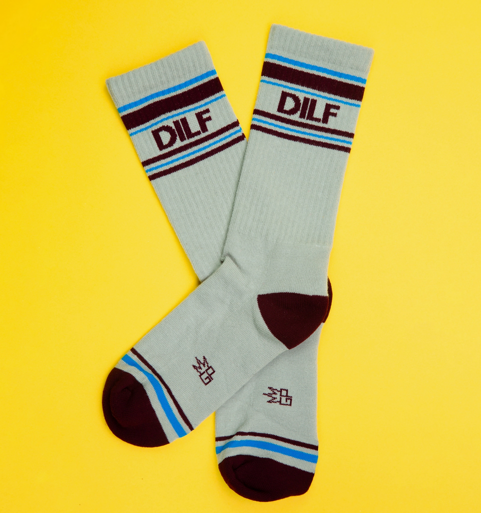 A pair of white tube socks with brown and blue stripes that read "DILF" in brown letters. 